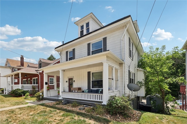 view of front of home featuring a front lawn and a porch