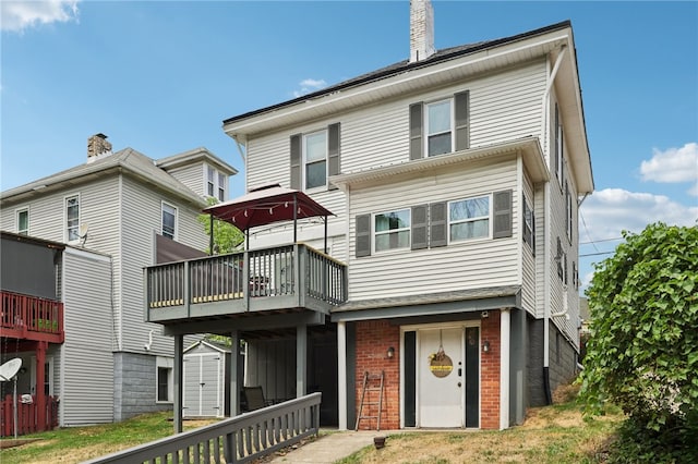 back of property featuring a wooden deck