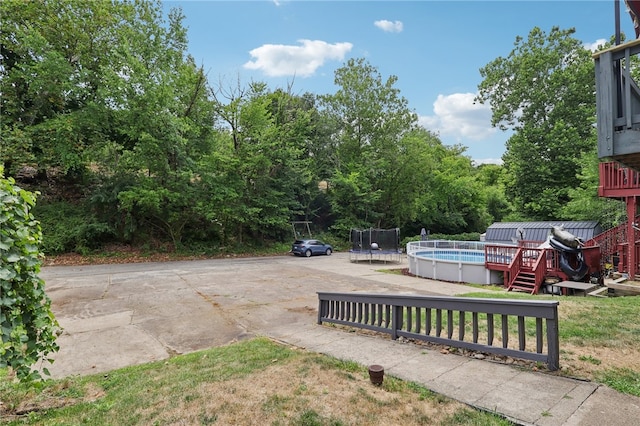 view of yard with a pool side deck