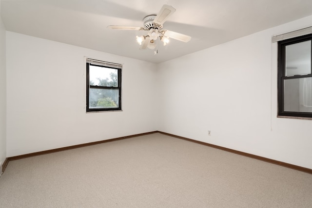 carpeted empty room with ceiling fan