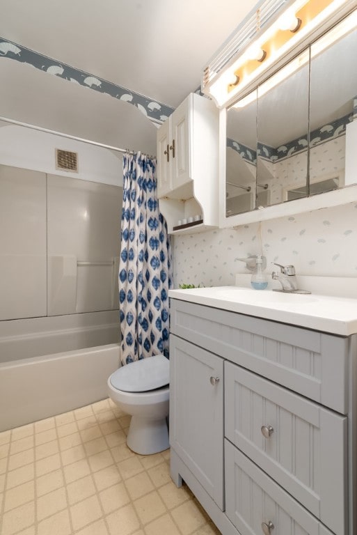 full bathroom with vanity, toilet, and shower / tub combo with curtain