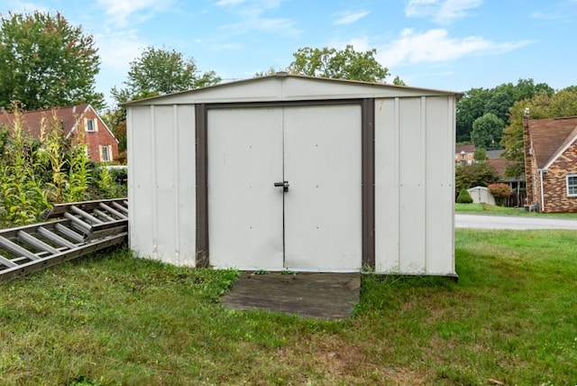 view of outbuilding featuring a lawn