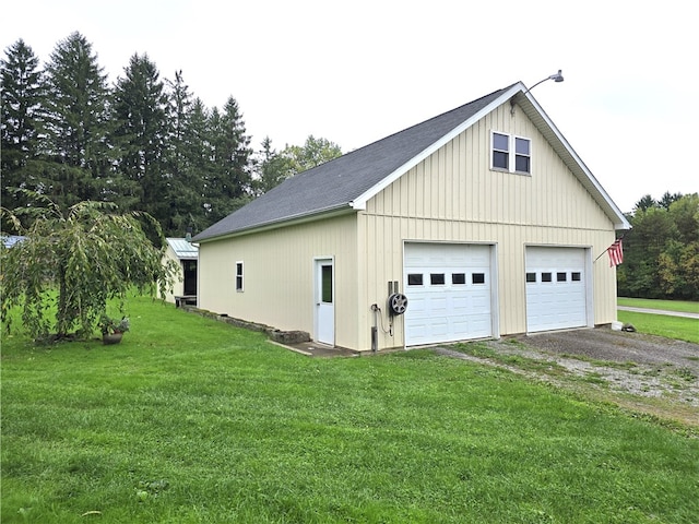 garage featuring wood walls and a yard