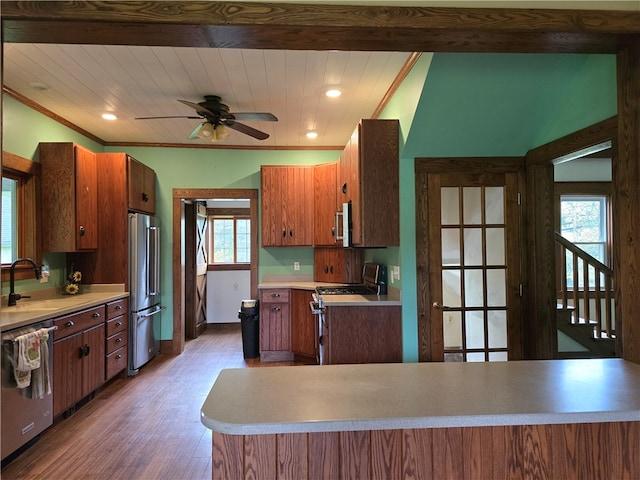 kitchen featuring sink, appliances with stainless steel finishes, light hardwood / wood-style floors, and wood ceiling