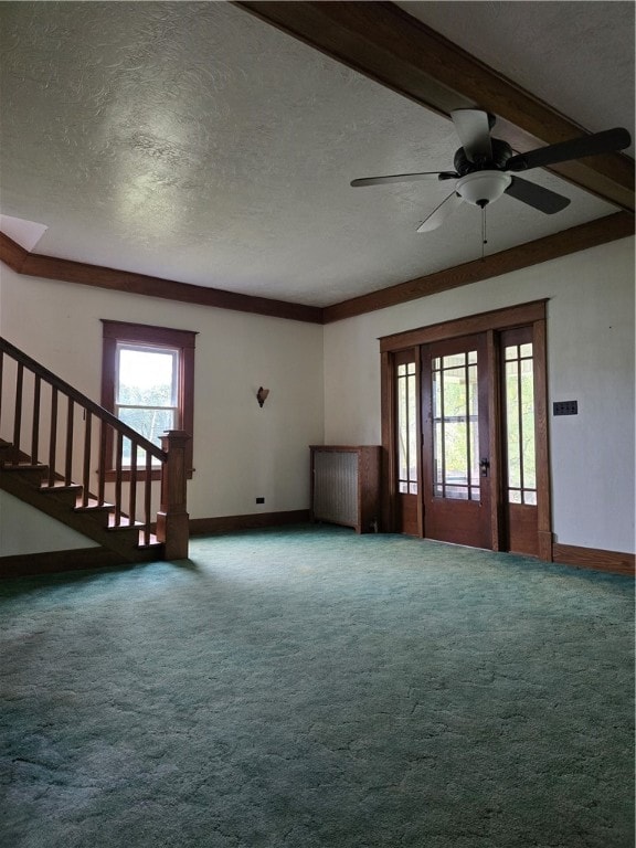 unfurnished living room with ceiling fan, a textured ceiling, beam ceiling, and carpet