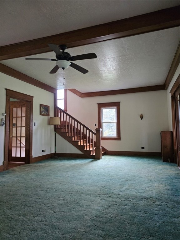 unfurnished living room with carpet, a textured ceiling, beamed ceiling, and ceiling fan