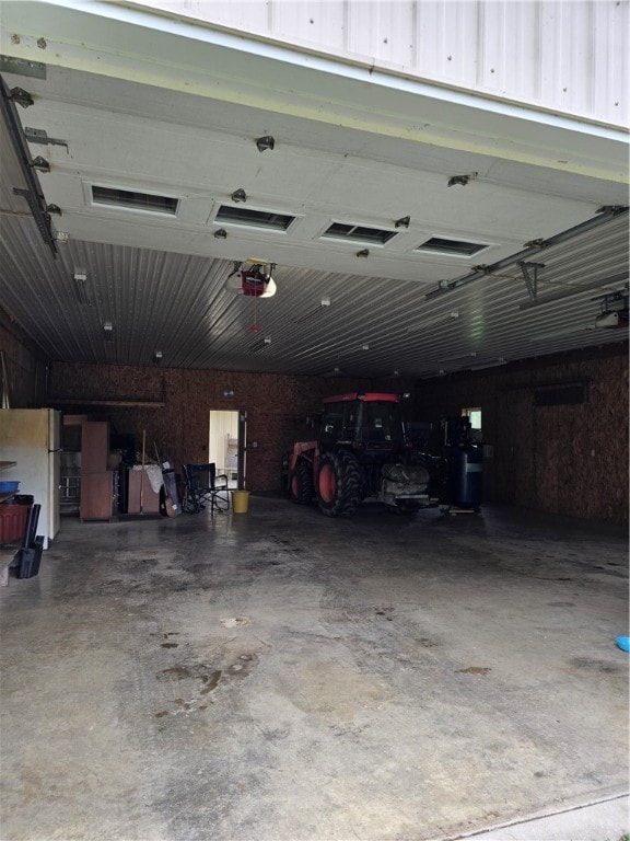 garage featuring a garage door opener and white fridge