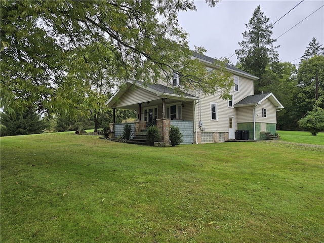 exterior space featuring covered porch, central air condition unit, and a yard