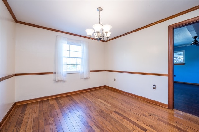 unfurnished room featuring hardwood / wood-style floors, ceiling fan with notable chandelier, and crown molding