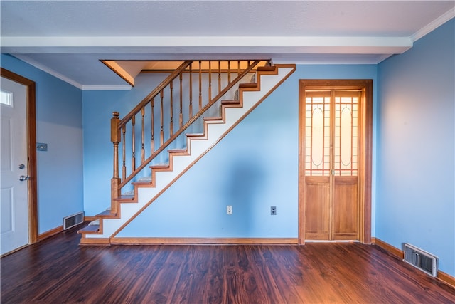 foyer entrance featuring dark hardwood / wood-style flooring and crown molding