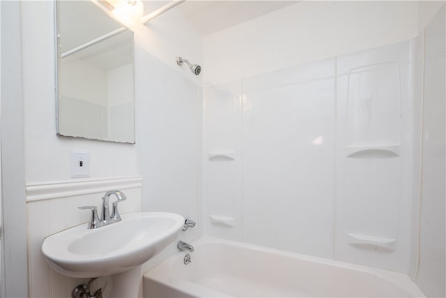 bathroom with shower / washtub combination and sink