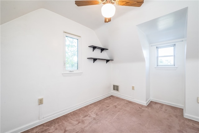 bonus room featuring ceiling fan, lofted ceiling, and light carpet