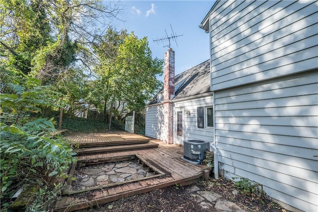 view of home's exterior with central AC unit and a deck