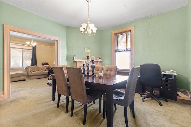 dining room with a wealth of natural light, a chandelier, and carpet flooring