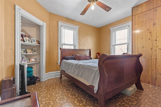 bedroom with multiple windows and ceiling fan