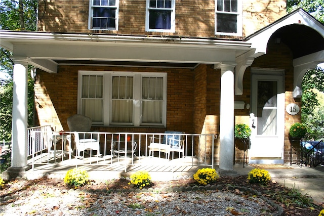 view of exterior entry featuring a porch