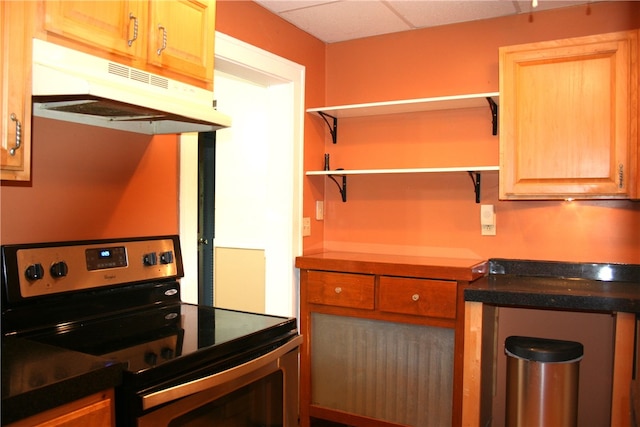 kitchen featuring a drop ceiling and electric stove