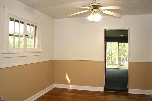 unfurnished room featuring ceiling fan and dark hardwood / wood-style flooring