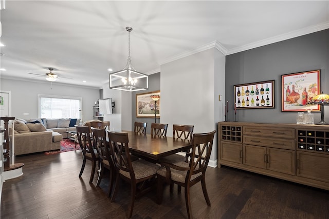 dining space with dark wood-type flooring, ceiling fan with notable chandelier, and ornamental molding