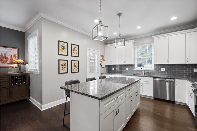 kitchen featuring white cabinetry, a center island, stainless steel dishwasher, and dark hardwood / wood-style floors