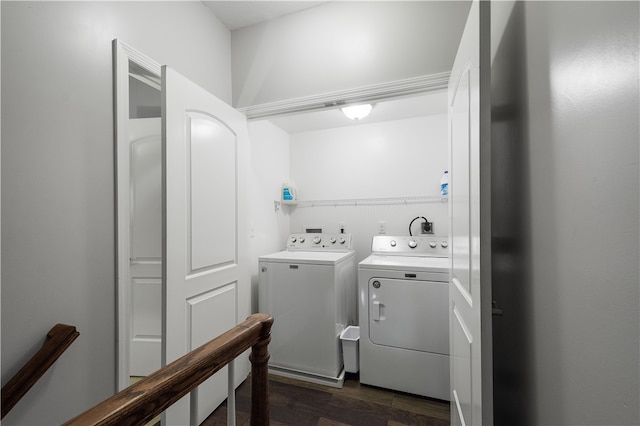 clothes washing area featuring dark hardwood / wood-style flooring and washing machine and clothes dryer