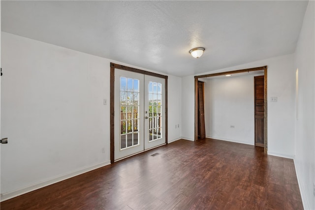 unfurnished room featuring dark hardwood / wood-style flooring, french doors, and a textured ceiling