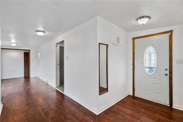 entryway with dark hardwood / wood-style flooring