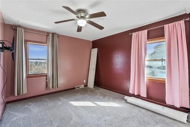 carpeted empty room with ceiling fan