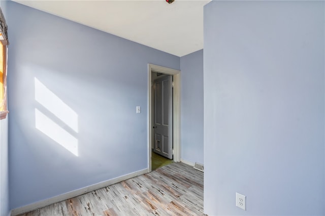 spare room featuring light hardwood / wood-style floors