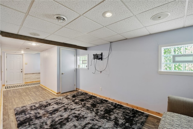 basement with wood-type flooring and a drop ceiling