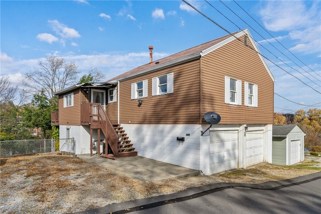 view of home's exterior featuring an attached garage and fence