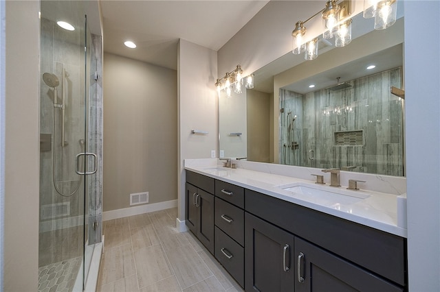 bathroom featuring vanity and an enclosed shower