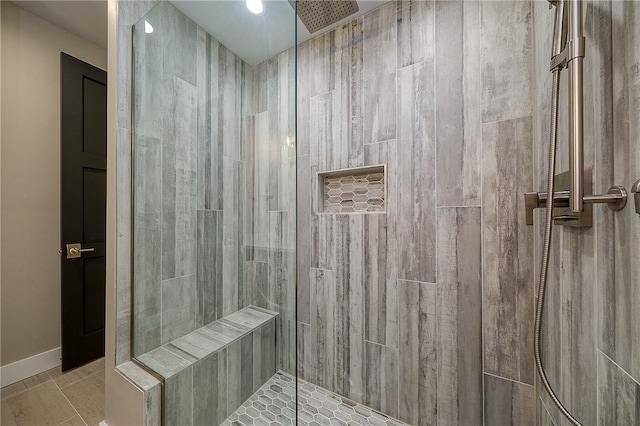 bathroom with tile patterned flooring and an enclosed shower