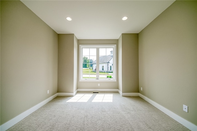 spare room with light carpet