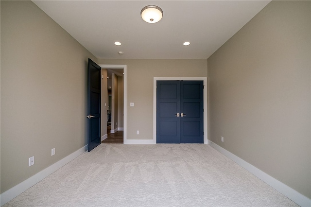 unfurnished bedroom featuring light carpet