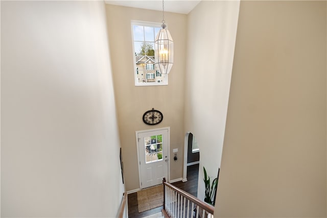 entryway with an inviting chandelier, plenty of natural light, and hardwood / wood-style floors