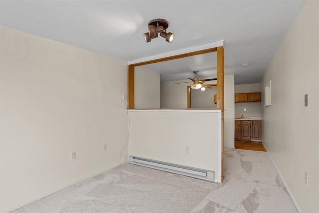 spare room featuring light colored carpet and baseboard heating