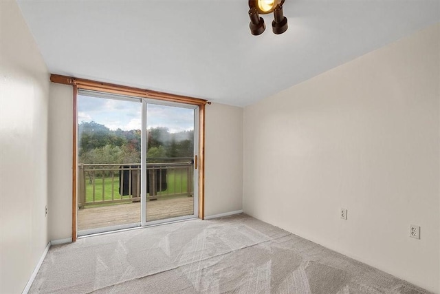 spare room featuring light colored carpet