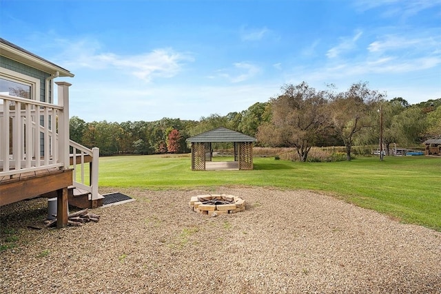 view of yard featuring a gazebo and a fire pit