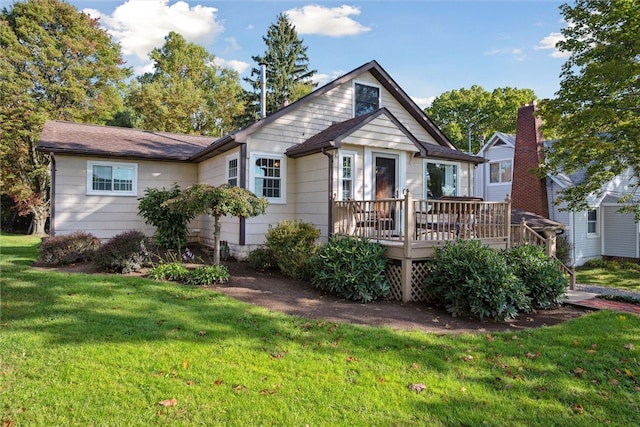 view of front of home featuring a front lawn and a deck