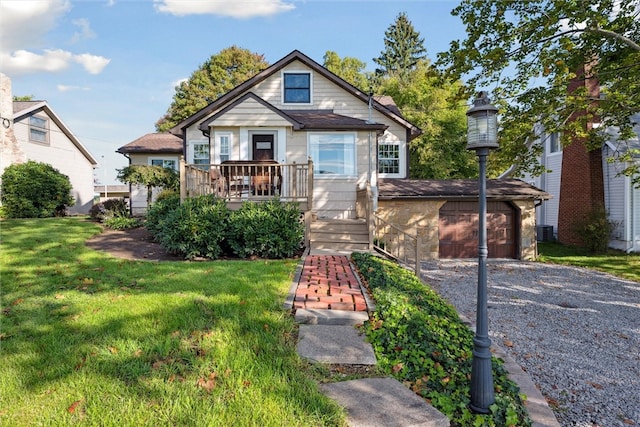 bungalow featuring a front lawn and central AC unit