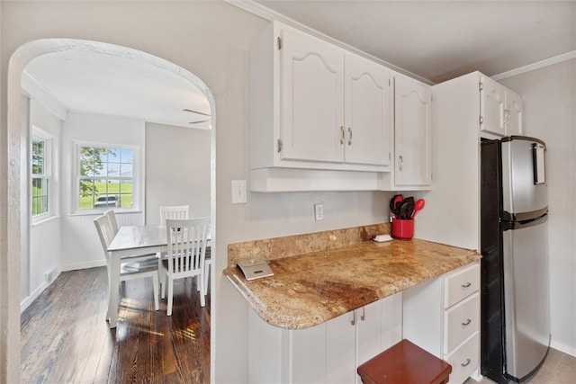 kitchen with stainless steel fridge, ceiling fan, crown molding, dark hardwood / wood-style floors, and white cabinets