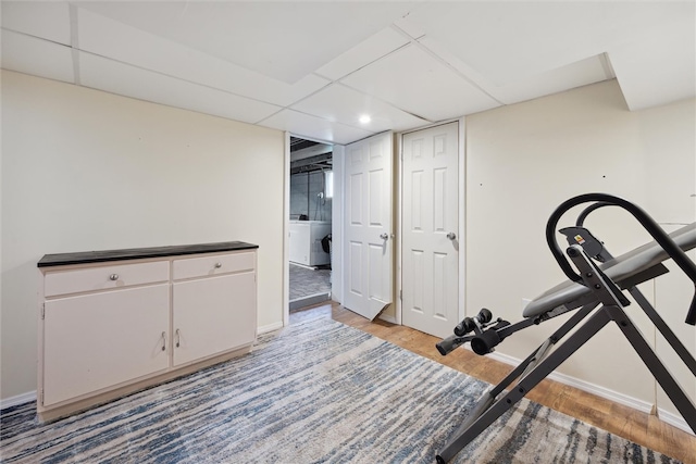 workout room featuring light hardwood / wood-style floors and washer / clothes dryer