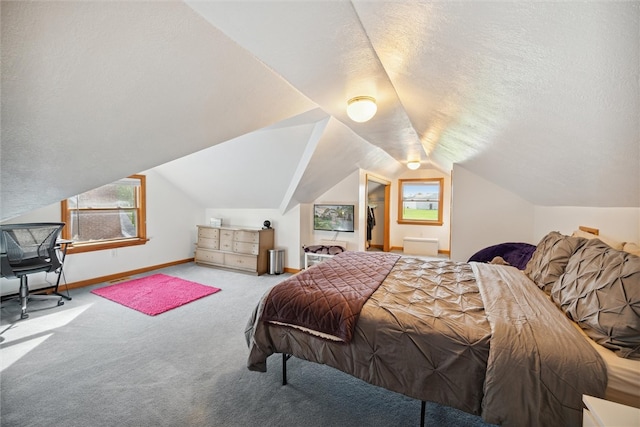 carpeted bedroom featuring lofted ceiling and a textured ceiling