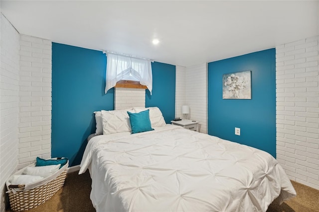 carpeted bedroom featuring brick wall