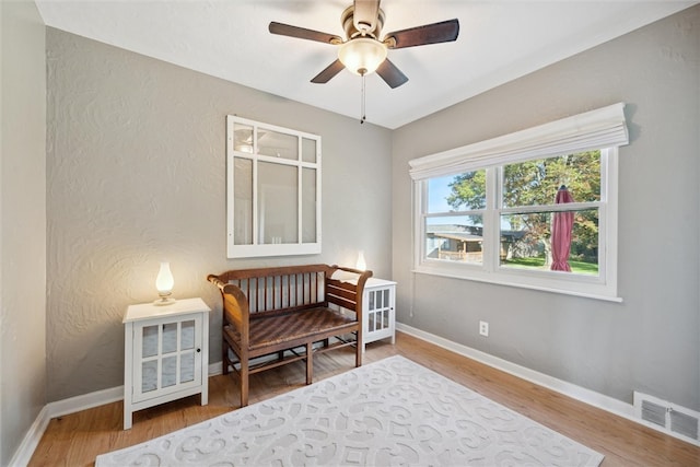 living area featuring ceiling fan and hardwood / wood-style floors