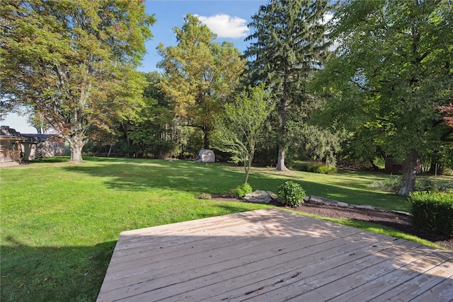 wooden deck featuring a lawn