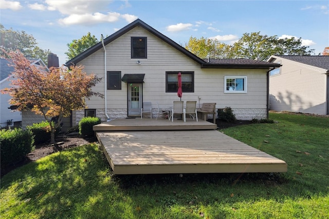 rear view of house with a yard and a deck