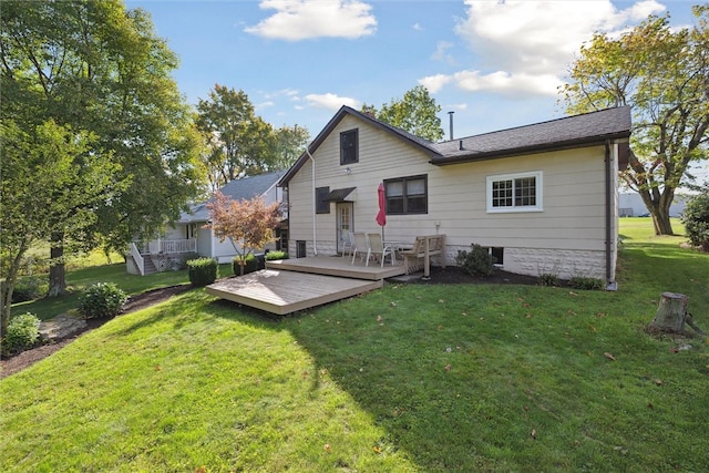 back of property with a yard and a deck