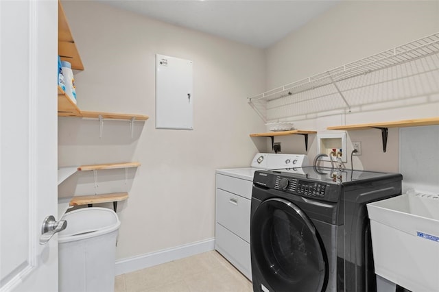 clothes washing area with sink and washer and dryer